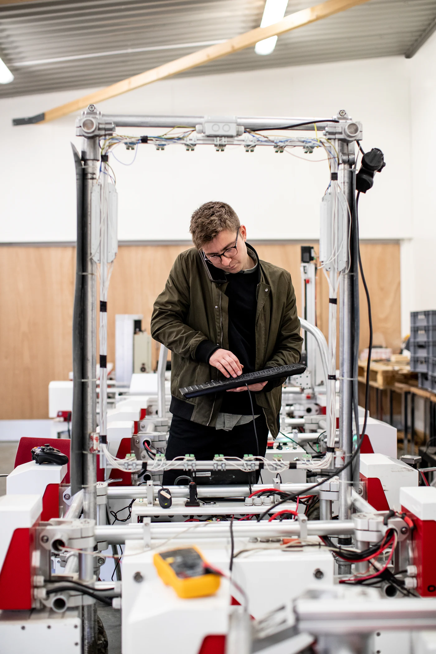 Technician checking a tablet in a production hall